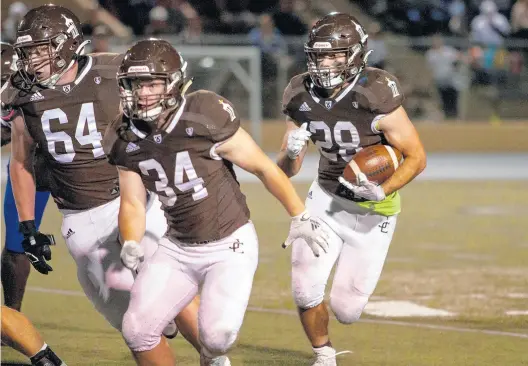  ?? ?? Joliet Catholic’s Anthony Birsa (64) and Ryan Louthan block for running back Vinny Iannantone against Crete-Monee.