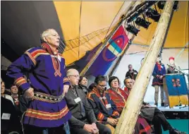  ?? CARL-JOHAN UTSI/ THE ASSOCIATED PRESS ?? Per Mikael Utsi, standing, a member of the Sami Parliament, takes part in the opening session of the parliament in Jokkmokk, northern Sweden, Thursday. Since the end of the last Ice Age, the Sami have wandered northern Europe, herding reindeer.