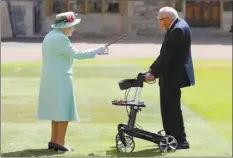  ?? Chris Jackson/Pool Photo via AP ?? Captain Sir Thomas Moore arrives to receive his knighthood from Britain’s Queen Elizabeth, during a ceremony at Windsor Castle on Friday.