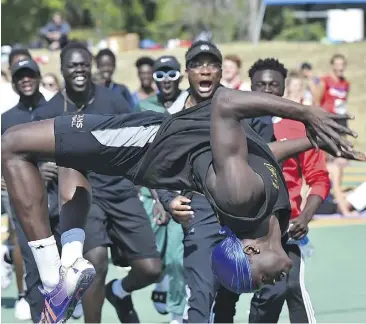  ?? ED KAISER ?? Ajou Ajou, a Grade 10 student at Harry Ainlay School, does a flip after breaking the provincial high school record of 2.02 metres in the high jump at the Edmonton zone track and field championsh­ips at Foote Field on Thursday.