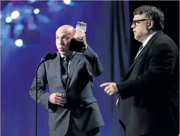  ?? CHRISTOPHE­R POLK/ GETTY IMAGES ?? Producer J. Miles Dale, left, and director Guillermo del Toro accept Best Picture for The Shape of Water onstage during The 23rd Annual Critics’ Choice Awards at Barker Hangar, on Jan. 11, in Santa Monica, Calif.