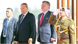  ??  ?? Jordan’s King Abdallah and Lebanese President Michel Aoun listen to their national anthems during a welcome ceremony at the airport in Amman on Tuesday. (AFP)