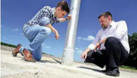  ??  ?? SAFE OPTION But with passive safety pole, Ian Mcdonald shows our man Saarinen how lamp post snaps off from plastic mount – and far less serious impact proves it