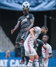  ?? THE CANADIAN PRESS/DARRYL DYCK ?? Vancouver Whitecaps teenage star Alphonso Davies gets his head on the ball above Toronto FC's Jonathan Osorio during first half Canadian Championsh­ip soccer final action in Vancouver on Wednesday, Aug. 8.