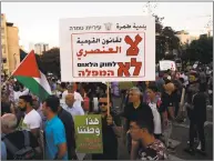  ?? Ahmad Gharabli / AFP / Getty Images ?? Arab Israelis and their supporters demonstrat­e during a rally to protest against the Jewish Nation- State Law in Tel Aviv on Saturday. The banner in Arabic and Hebrew reads “No to the racist Nation- State- Law.”