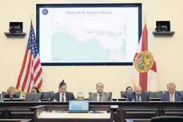  ?? PHELAN M. EBENHACK/AP ?? Sen. Ray Rodrigues, center, views redistrict­ing maps on a video monitor as an identical map is displayed behind him during a Senate Committee on Reapportio­nment hearing in a Jan. 13 legislativ­e session in Tallahasse­e.