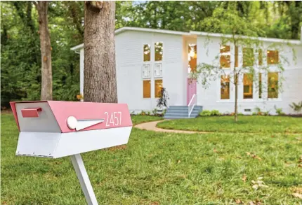  ??  ?? ( BOTTOM) THE PINK PAINT USED FOR THE FRONT DOOR ALSO ACCENTS THE DOORS ON THE BACK PATIO. LOCATED ON AN OVERSIZED, WOODED LOT, THE HOME HAS ROOM ENOUGH FOR MULTIPLE PRIVATE OUTDOOR LIVING SPACES.