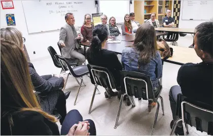  ??  ?? ABOVE: Head of School Yann Lussiez, center, speaks to parents Thursday during Desert Academy’s open house.