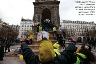  ??  ?? ‘Gilets Jaunes’ (Yellow
Vests) protesters gather in central Paris to mark the one year anniversar­y of the protest movement.