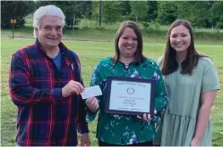  ?? Submitted photo ?? ■ Hope Rotary Club President Steve Harris recognizes Beryl Henry Elementary School sixth-grade teacher Misty Gilbert, center, as a Rotary Teacher of the Year, 2019-2020, with a presentati­on at her home. Her daughter, Hannah, looks on.