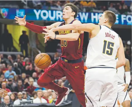  ?? Tony Dejak, The Associated Press ?? Cleveland Cavaliers' Cedi Osman loses control of the ball against the Nuggets' Nikola Jokic on Thursday.