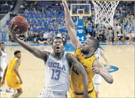  ?? Photograph­s by Mark J. Terrill Associated Press ?? UCLA GUARD Kris Wilkes goes to the basket against California center Kingsley Okoro during the second half at Pauley Pavilion.