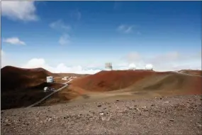  ?? CALEB JONES — THE ASSOCIATED PRESS FILE ?? In this file photo, observator­ies and telescopes sit atop Mauna Kea, Hawaii’s tallest mountain and the proposed constructi­on site for a new $1.4 billion telescope, near Hilo, Hawaii.