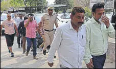  ?? SANT ARORA/ HT ?? The accused in ‘cash for job’ scam being taken by the police to a court in Panchkula on Friday.