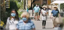  ?? MORGAN TIMMS/Taos News ?? Pedestrian­s stroll through John Dunn Shops Wednesday (July 1.) In an amendment to the existing COVID-19 emergency order, Taos councilors required all those within town limits to wear a mask on public property.