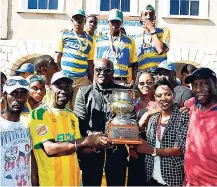  ??  ?? Lloyd ‘Bagga’ Stewart (left) stands with Rusea’s coach Vassell Reynolds (second left) and Mayor of Lucea and president of Hanover Football Associatio­n Mayor Sheridan Samuels who were among the persons posing with the daCosta Cup trophy in the Sir...