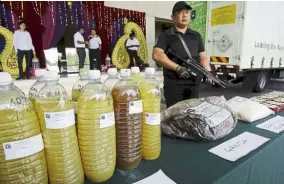  ?? — Bernama ?? To the burner: An officer standing guard by some of the seized drugs that will be destroyed.