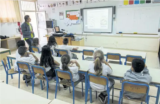  ??  ?? EAGER TO LEARN: Children study Sanna in the Cypriot capital Nicosia. The language is a form of Arabic influenced by the Aramaic spoken by Jesus.