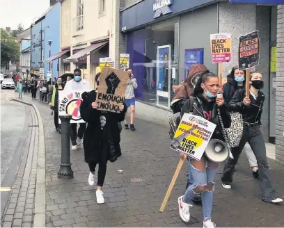  ?? Picture: Stand Up To Racism West Wales ?? Protesters marched from Guildhall Square to the Picton Monument in Carmarthen as part of a Black Lives Matter protest calling for the monument to be removed and replaced with a memorial to victims of slavery.