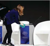  ?? — Reuters ?? FINAL TOUCH: A staff member of the World Economic Forum cleans chairs in the congress centre before the annual meeting of the World Economic Forum (WEF) in Davos, Switzerlan­d.