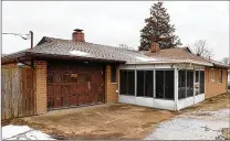  ?? ?? The enclosed porch has a concrete floor, wood-plank walls and screen-enclosed windows. A concrete driveway leads up to the side of the house and wraps around to the garage at the back of the house. A new garage door is on a delayed order.