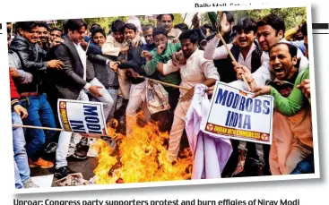  ??  ?? Uproar: Congress party supporters protest and burn effigies of Nirav Modi