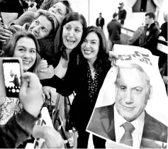  ??  ?? Israel’s Minister of Culture and Sport Miri Regev and supporters of the Likud Party hold a photo of Netanyahu at the launch of Likud party’s election campaign in Ramat Gan, Israel. — Reuters photo