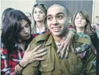  ?? (Jim Hollander, pool/Reuters) ?? ELOR AZARIA is embraced by his mother at the start of his sentencing hearing at a military court in Tel Aviv on Tuesday.