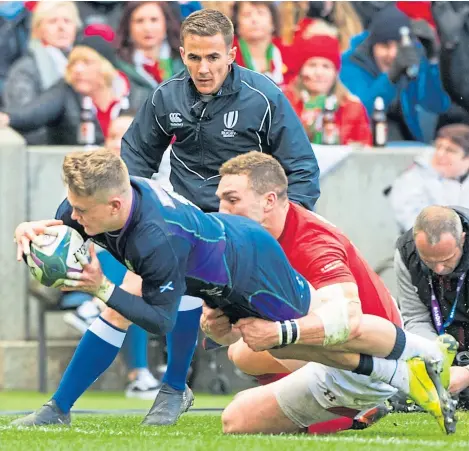  ?? SNS. ?? Darcy Graham dives over the line to grab Scotland’s only try of the game miday through the second half.