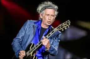  ?? Rich Fury/iInvision/Associated Press ?? Keith Richards, shown playing at a May 24 Rolling Stones concert in San Diego, will be the subject of a Sept. 18 documentar­y — “Keith Richards — Under the Influence” — on Netflix.