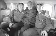  ?? AP/Roscosmos ?? Dmitry Rogozin (center), the head of Russian space agency Roscosmos, sits with cosmonaut Alexei Ovchinin (left) and U.S. astronaut Nick Hague at Star City, Russia, in an undated photo. Rogozin promised that Ovchinin and Hague will get another chance to go to space after Thursday’s aborted launch.