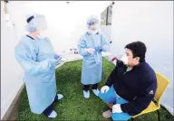  ?? Matthew Brown / Hearst Connecticu­t Media file photo ?? A Connecticu­t resident gets tested for COVID-19 at a testing site in Greenwich in May.