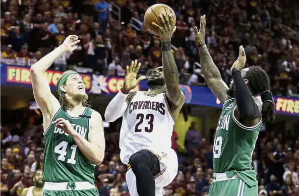 ??  ?? On a high: Cleveland Cavaliers’ LeBron James goes up for a shot as he is surrounded by Boston Celtics’ Kelly Olynyk (left) and Jae Crowder during the NBA Eastern Conference finals on Tuesday. — AP