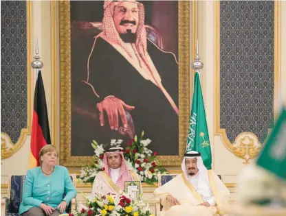  ?? — AFP ?? RIYADH: A handout picture provided by the Saudi Royal Palace yesterday shows German Chancellor Angela Merkel (left) sitting next to Saudi Arabia’s King Salman bin Abdulaziz Al-Saud (right) during a meeting in Riyadh.