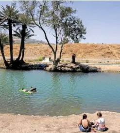  ?? ?? NEAR THE SOURCE A photo taken on July 13, 2021, shows Israelis camping by the Jordan River near the Sea of Galilee, or Lake Tiberias, in Israel.