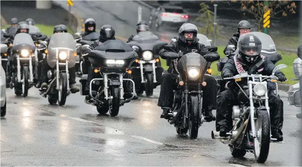  ?? RICHARD LAM/PNG ?? Members of the Hells Angels ride to Oceanview Cemetery in Burnaby during their annual ‘Screwy Ride’ to honour the murdered friend Dave ‘Screwy’ Schwartz in Vancouver on Saturday. Members of the Vancouver Police and RCMP kept a watch on the event.