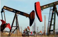  ?? — AFP ?? Pump jacks and wells are seen in an oil field on the Monterey Shale formation near California.