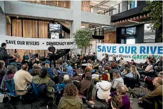  ?? PHOTO: GEORGE HEARD/STUFF ?? Greenpeace protesters occupying the Environmen­t Canterbury office in Christchur­ch yesterday.