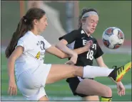  ?? KEN SWART — FOR MEDIANEWS GROUP ?? South Lyon’s Gianna Spano (22) gets a leg up on South Lyon East’s Autumn Neville (18) during the Lakes Valley Conference semi-final match played on Thursday at South Lyon East High School. The Lions lost 5-0as the Cougars advance to next week’s conference final.