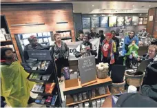  ?? JACQUELINE LARMA/AP ?? On Monday, demonstrat­ors filled the Starbucks in Philadelph­ia where two black men were arrested.