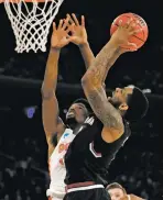  ?? JULIO CORTEZ THE ASSOCIATED PRESS ?? South Carolina guard Sindarius Thornwell, right, puts up a shot against Florida forward Kevarrius Hayes during the second half of the East Regional championsh­ip game of the NCAA Tournament on Sunday in New York.