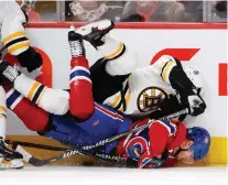  ?? ALLEN MCINNIS ?? Boston Bruins defenceman Torey Krug jumps on Montreal Canadiens left wing Artturi Lehkonen, driving his head in to the ice during NHL action Saturday at the Bell Centre.