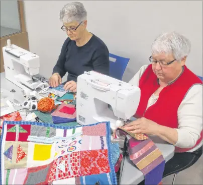  ?? BRAD COLLINS/JOURNAL PIONEER ?? Kay Wall, left, of New Annan and Elaine Burrows of Summerside sit down behind their sewing machines to start putting together their fidget quilts.