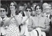  ?? TOBY MELVILLE / REUTERS ?? Kate (left) and Meghan (right) applause after a Tennis game at Wimbledon in London on July 14.