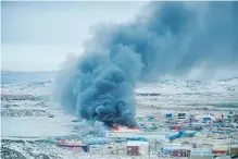  ??  ?? A fire burns at a Northmart store in Iqaluit, Nunavut on Wednesday.