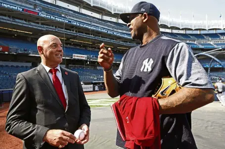  ??  ?? Sharing a light
moment: Former Liverpool goalkeeper Bruce Grobbelaar (left) speaking to New York Yankees pitcher CC Sabathia at the Yankee Stadium in New York on Wednesday. — AP