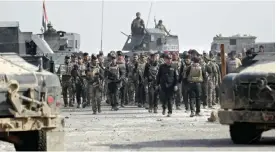  ??  ?? MOSUL, Iraq: Iraqi Special Forces parade with Staff Lieutenant General Abdul Ghani Al-Asadi, commander of the Counter-Terrorism Service (CTS) in a recently recaptured district of southeast Mosul, yesterday. — AFP