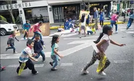  ?? Pedro Pardo AFP/Getty Images ?? CHILDREN displaced by the quake play in a street in Mexico City last month.