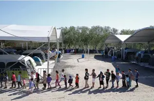  ?? Jerry Lara / Staff photograph­er ?? Children play at a migrant camp last year in Matamoros, Mexico. Asylum-seekers under the Migrant Protection Protocols, which launched the camp, soon will be able to pursue their cases in the U.S.