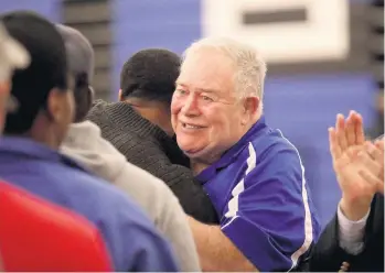  ?? STEVE EARLEY/STAFF ?? Former Norview wrestling coach Ken Whitley is greeted by some of his wrestlers as he is honored for 52 years of coaching on Wednesday at Norview. The Pilots defeated Norcom (63-18), Booker T. Washington (66-18) and Lake Taylor (50-25).